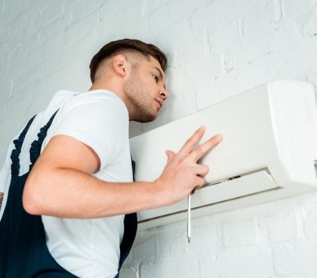 handsome-worker-installing-air-conditioner-YHHQCS7 handsome-worker-installing-air-conditioner-YHHQCS7
